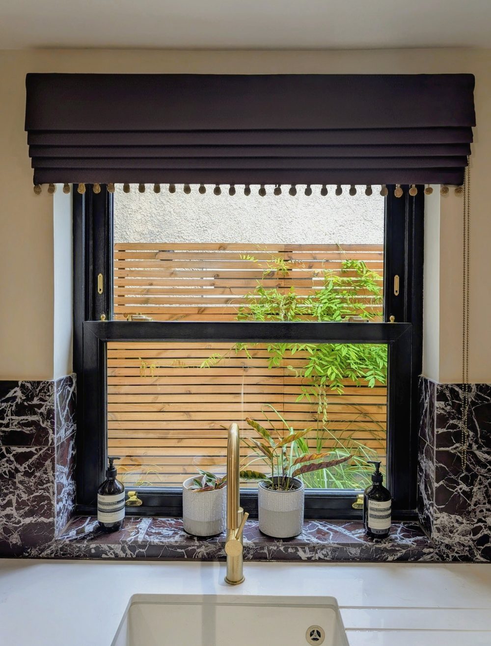 A finished Roman blind fitted above a kitchen window