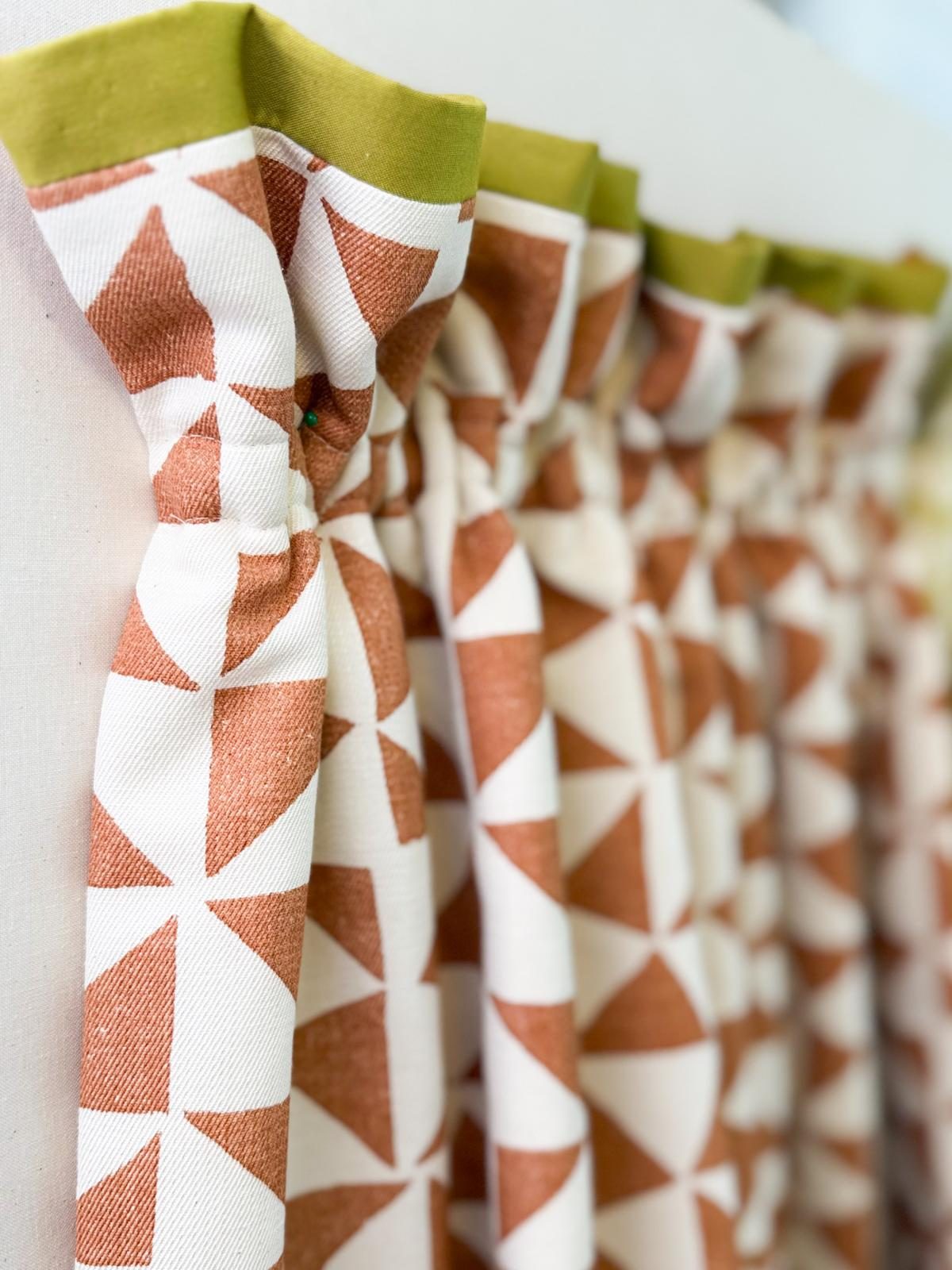 Terracotta geometric curtains with a contrast green leading edge