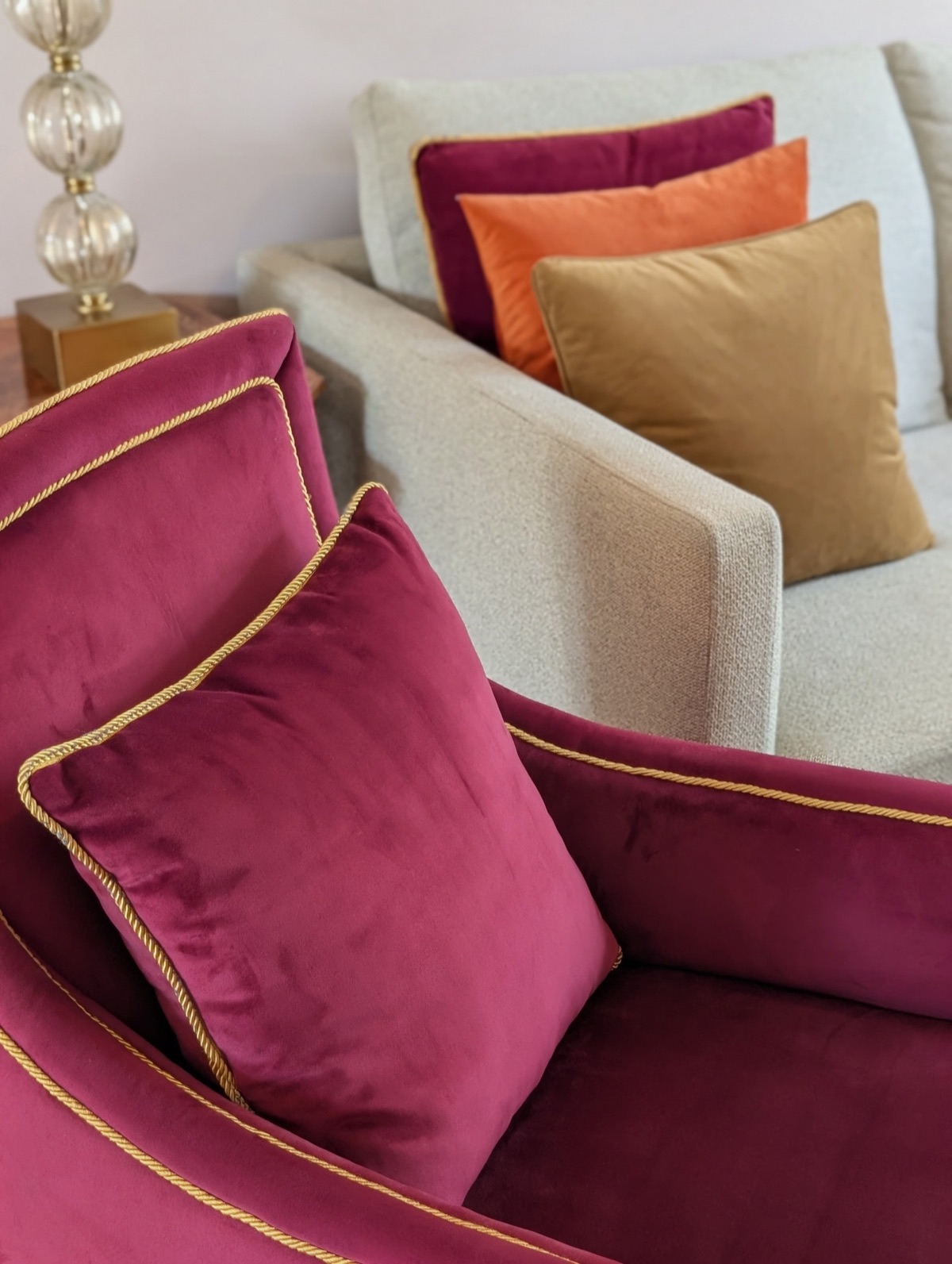Burgundy velvet cushions and armchair finished with gold rope piping